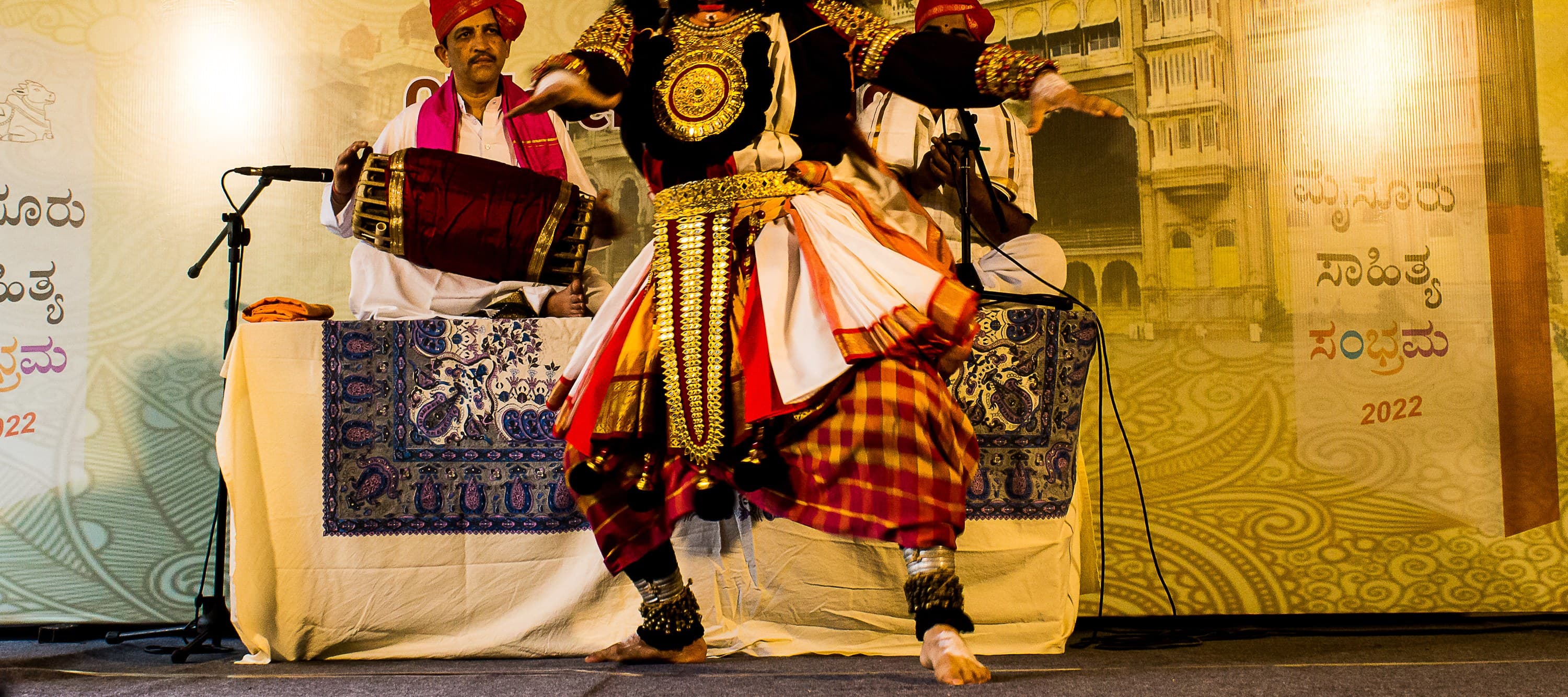 Yakshagana Himmela musicians playing maddale beside a Badagutittu performer on stage